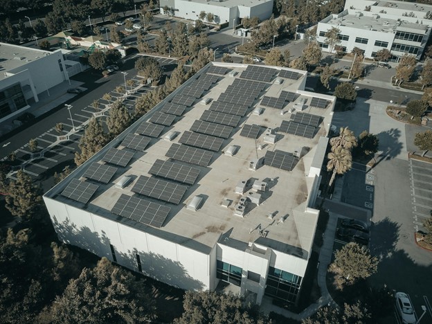 Aerial view of a large commercial warehouse fitted with a rooftop solar array